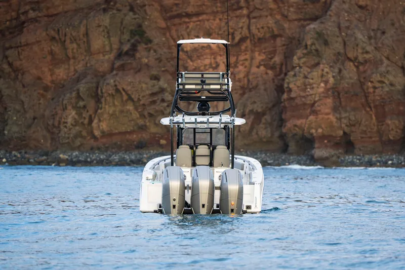 Slide: The Image of 2024 Everglades 365 Center Console boat on water, rocky cliff background. - 18