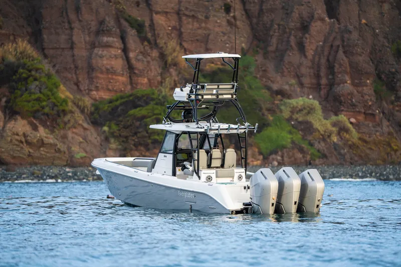 Slide: The Image of 2024 Everglades 365 Center Console boat on water, rocky cliff background. - 19