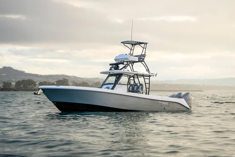 Slide: The Image of 2024 Everglades 365 Center Console boat on calm water at sunset. - 22