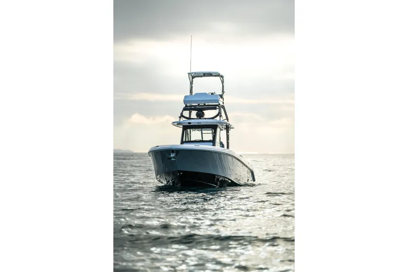 Slide: The Image of 2024 Everglades 365 Center Console boat on calm water at sunrise. - 24