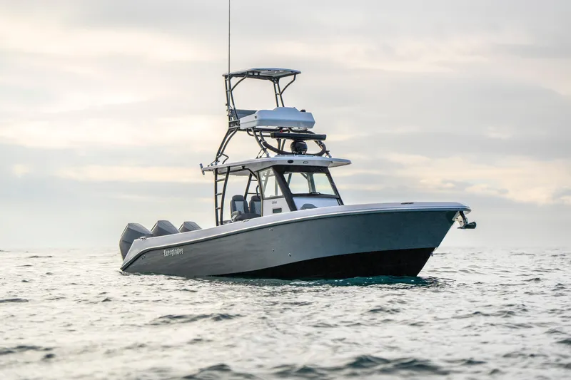 Slide: The Image of 2024 Everglades 365 Center Console boat on open water under cloudy sky. - 26