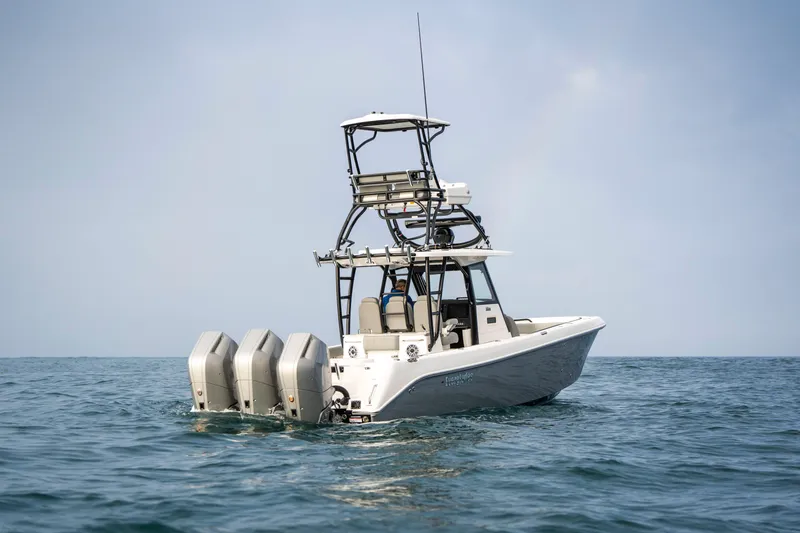Slide: The Image of 2024 Everglades 365 Center Console boat on open water, featuring four powerful engines. - 30