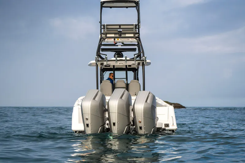 Slide: The Image of 2024 Everglades 365 Center Console boat with triple engines on open water. - 31