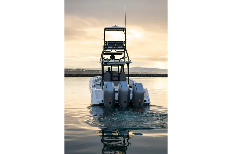Slide: The Image of 2024 Everglades 365 Center Console boat on calm water at sunset. - 4