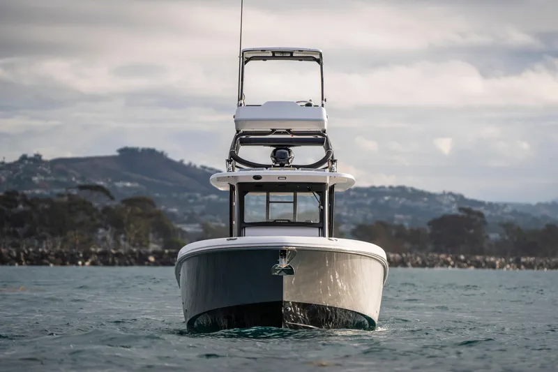 Slide: The Image of 2024 Everglades 365 Center Console boat on water, scenic coastal backdrop. - 40