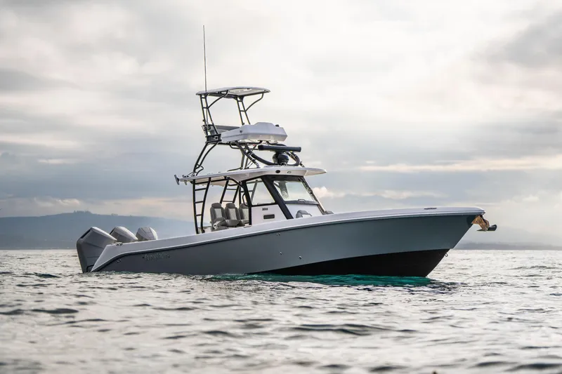 Slide: The Image of 2024 Everglades 365 Center Console boat on open water under cloudy sky. - 44