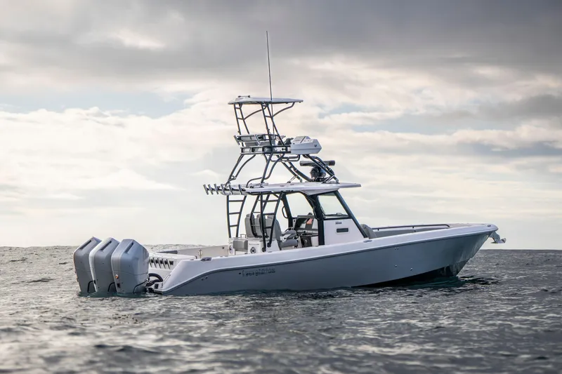 Slide: The Image of 2024 Everglades 365 Center Console boat on open water under cloudy sky. - 46