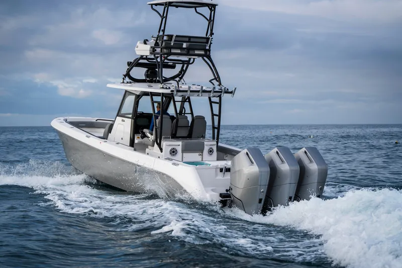 Slide: The Image of 2024 Everglades 365 Center Console boat cruising on open water. - 49