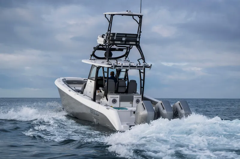 Slide: The Image of 2024 Everglades 365 Center Console boat cruising on open water. - 50