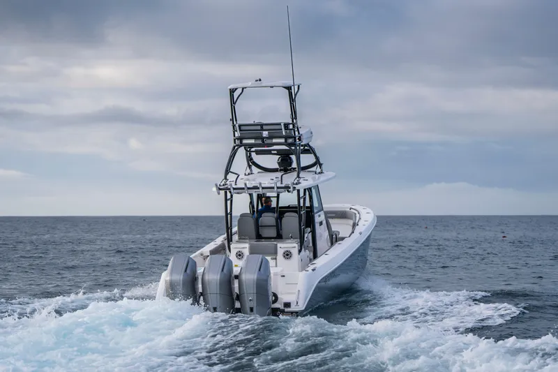 Slide: The Image of 2024 Everglades 365 Center Console boat cruising on open water. - 52