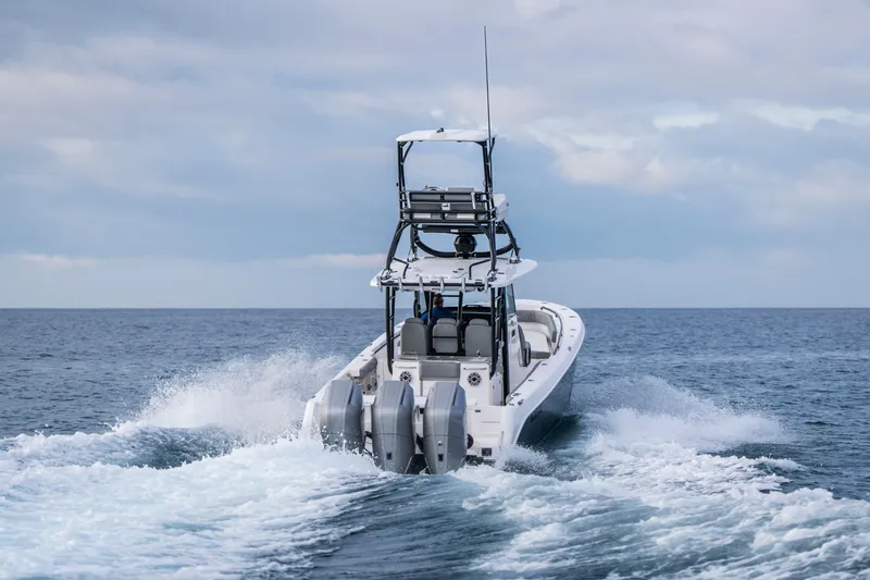 Slide: The Image of 2024 Everglades 365 Center Console boat cruising on open water. - 53