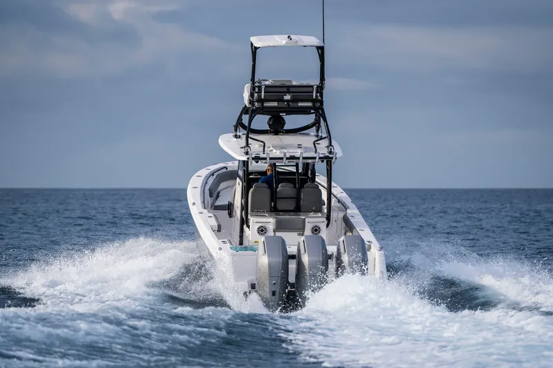 Slide: The Image of 2024 Everglades 365 Center Console boat cruising on open water. - 54