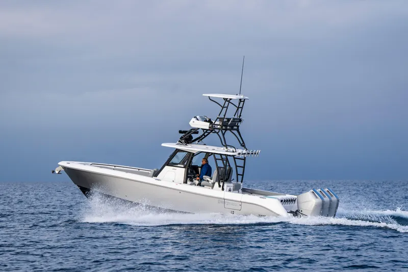 Slide: The Image of 2024 Everglades 365 Center Console boat cruising on open water. - 55