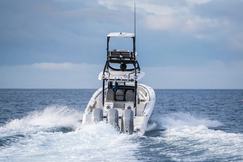 Slide: The Image of 2024 Everglades 365 Center Console boat cruising on open water. - 56
