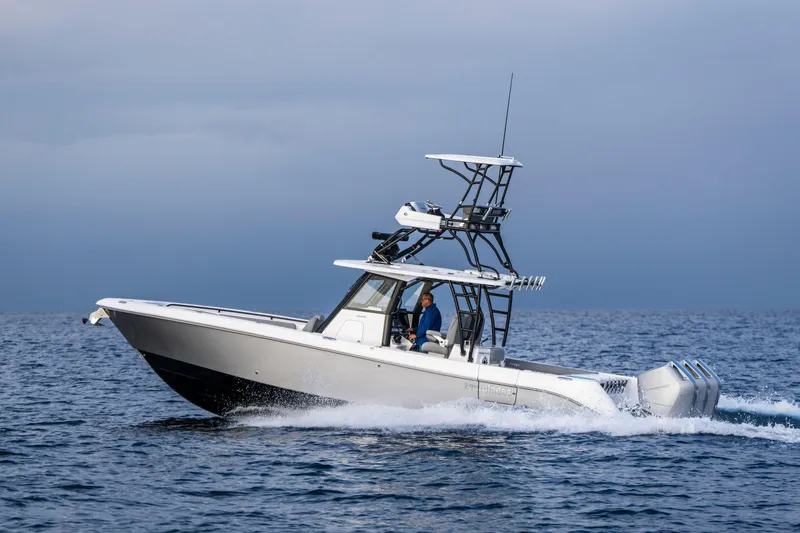 Slide: The Image of 2024 Everglades 365 Center Console boat cruising on open water. - 57