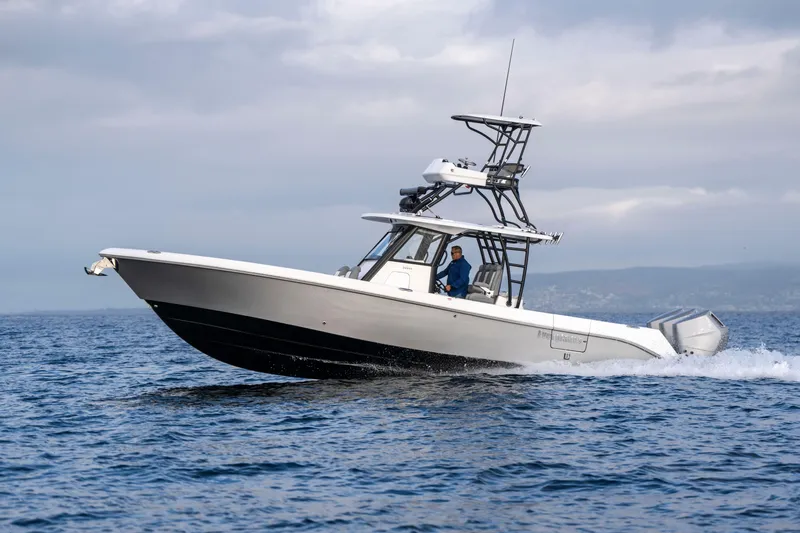 Slide: The Image of 2024 Everglades 365 Center Console boat cruising on open water. - 59