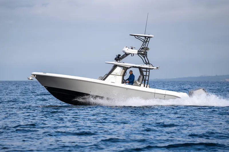 Slide: The Image of 2024 Everglades 365 Center Console boat cruising on open water. - 60