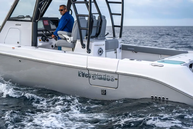 Slide: The Image of 2024 Everglades 365 Center Console boat cruising on open water. - 62