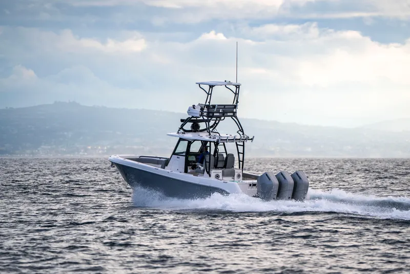 Slide: The Image of 2024 Everglades 365 Center Console boat cruising on open water. - 65