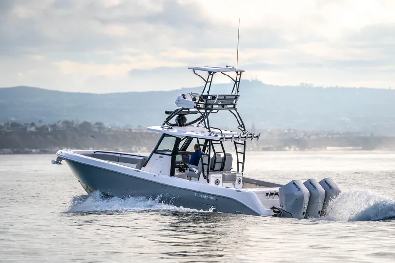 Slide: The Image of 2024 Everglades 365 Center Console boat cruising on open water. - 69