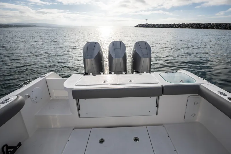 Slide: The Image of 2024 Everglades 365 Center Console boat with triple engines on open water. - 79