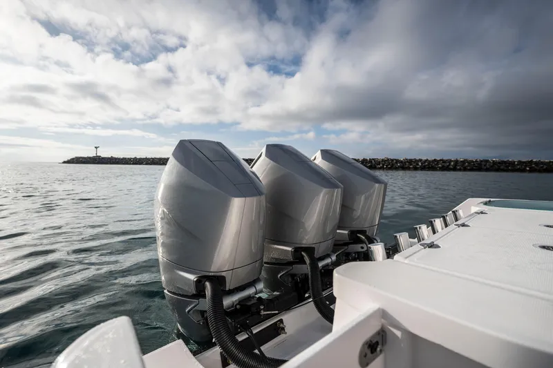Slide: The Image of 2024 Everglades 365 Center Console with triple outboard engines on open water. - 81