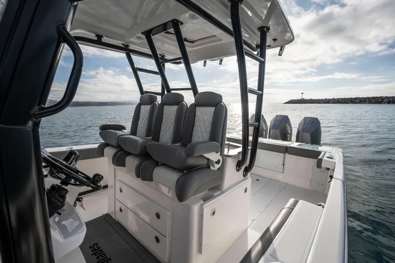 Slide: The Image of 2024 Everglades 365 Center Console boat interior with seating and ocean view. - 85
