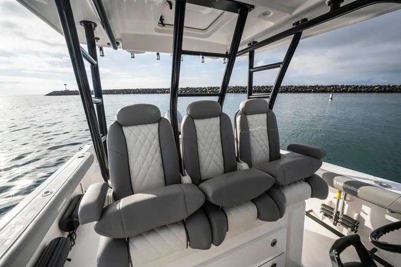 Slide: The Image of 2024 Everglades 365 Center Console boat interior with luxurious seating on calm water. - 86