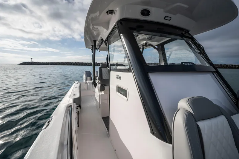Slide: The Image of 2024 Everglades 365 Center Console boat on calm water, showcasing sleek design and modern features. - 87