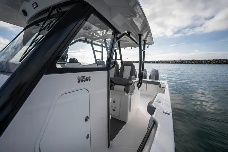 Slide: The Image of 2024 Everglades 365 Center Console boat on water, showcasing sleek design and seating. - 88