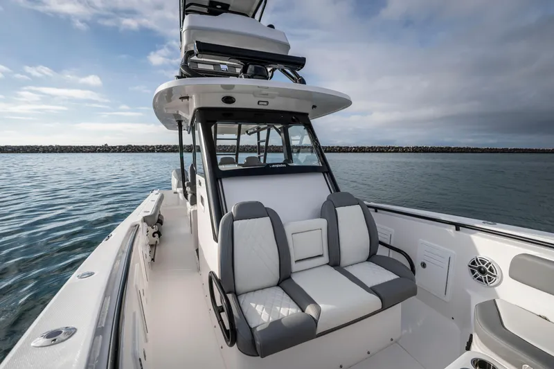 Slide: The Image of 2024 Everglades 365 Center Console boat on calm water, showcasing seating and helm. - 90