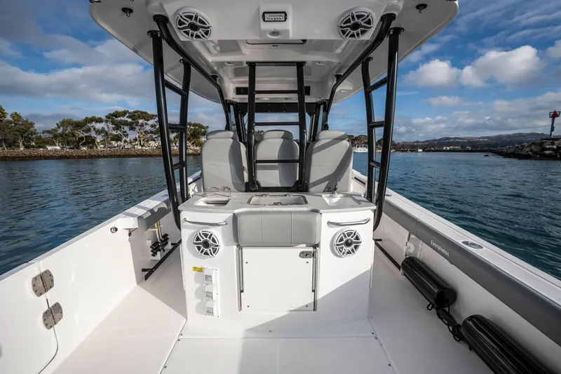 Slide: The Image of 2024 Everglades 365 Center Console boat interior with seating and speakers on a calm waterway. - 91