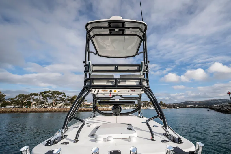 Slide: The Image of 2024 Everglades 365 Center Console boat on water, showcasing sleek design and sturdy structure. - 92