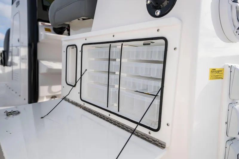 Slide: The Image of 2024 Everglades 365 Center Console storage compartment with organized tackle boxes. - 97