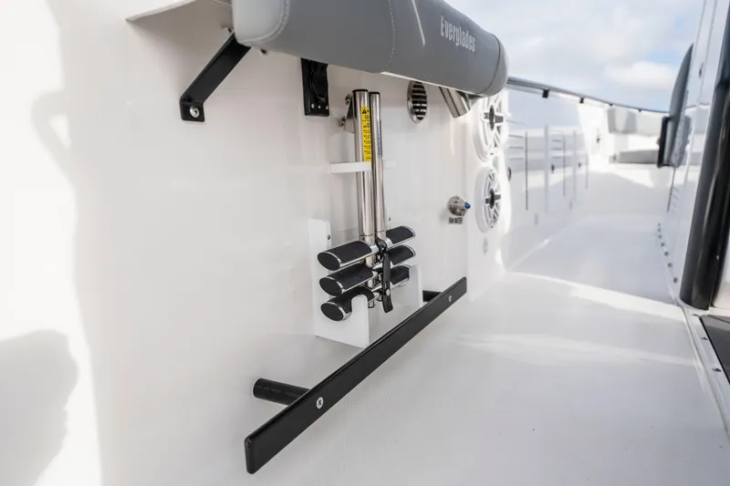 Slide: The Image of 2024 Everglades 365 Center Console boat interior with rod holders and speakers. - 98