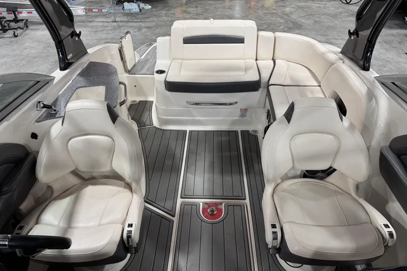 Slide: The Image of 2016 Chaparral 244 Xtreme boat interior with white seating and gray flooring. - 10