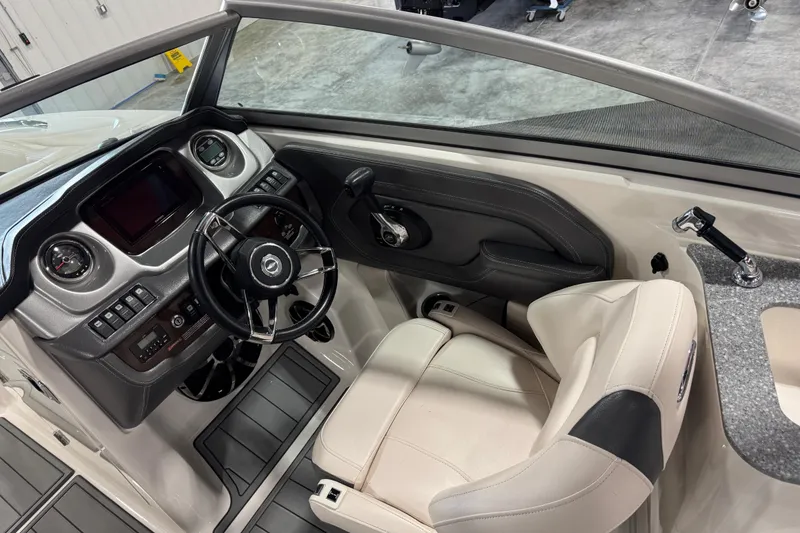 Slide: The Image of 2016 Chaparral 244 Xtreme boat interior with steering wheel and dashboard controls. - 13