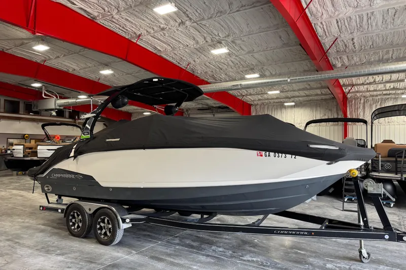 Slide: The Image of 2016 Chaparral 244 Xtreme boat in a showroom, covered and on a trailer. - 15