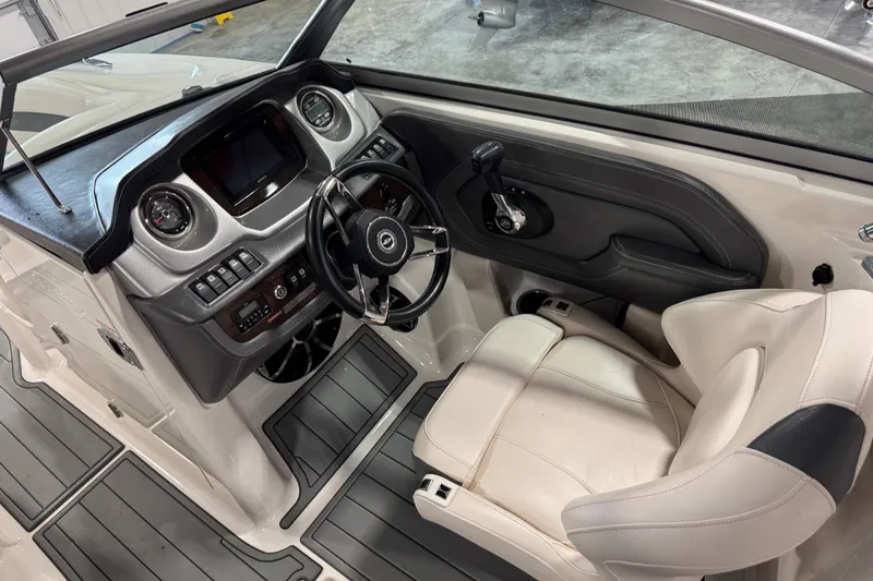 Slide: The Image of Interior of 2016 Chaparral 244 Xtreme boat, featuring steering wheel and dashboard controls. - 8