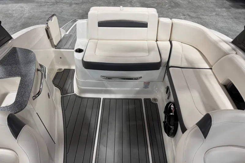 Slide: The Image of 2016 Chaparral 244 Xtreme boat interior with white seating and gray flooring. - 9