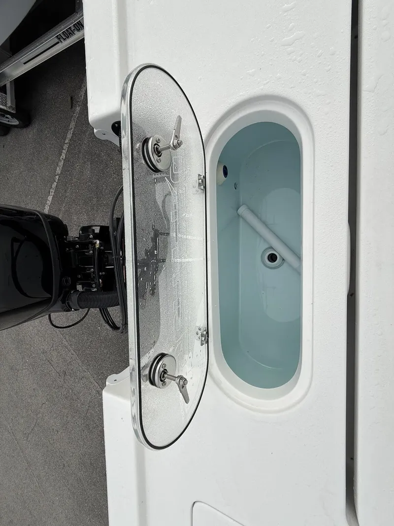Slide: The Image of Sea Pro 250 Bay 2026 boat with open storage compartment. - 13