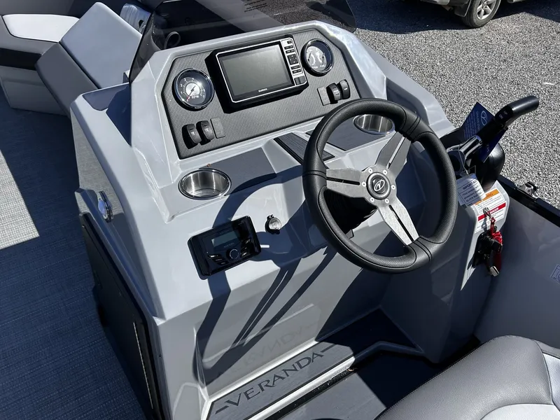 Slide: The Image of Veranda Vista Series TRITOON-150HP 2026 helm with steering wheel and controls. - 7