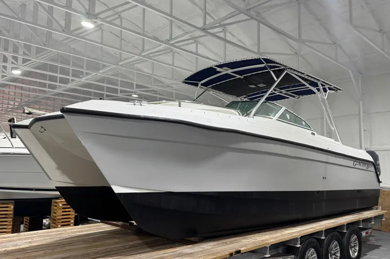 Slide: The Image of 2003 Glacier Bay 2640SX Renegade boat in indoor storage on a trailer. - 11