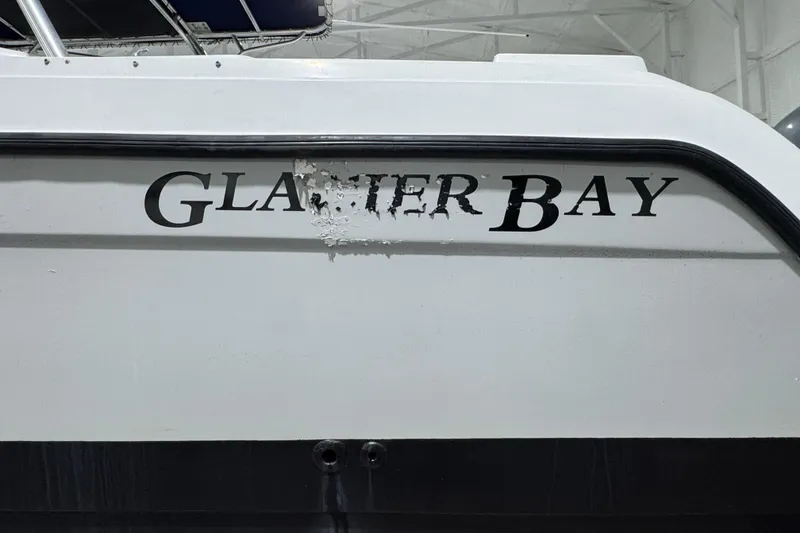 Slide: The Image of 2003 Glacier Bay 2640SX Renegade boat with partially damaged logo. - 13