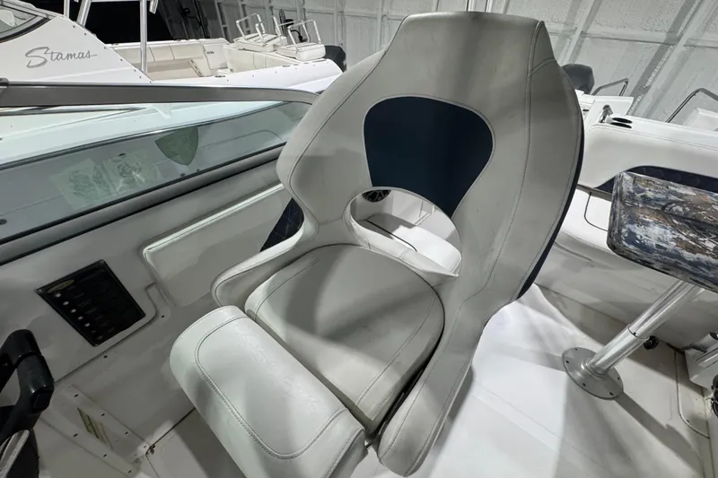 Slide: The Image of Captain's chair on 2003 Glacier Bay 2640SX Renegade boat, featuring sleek design and comfortable seating. - 15