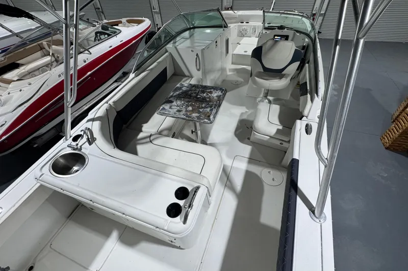 Slide: The Image of 2003 Glacier Bay 2640SX Renegade boat interior with seating and helm. - 21