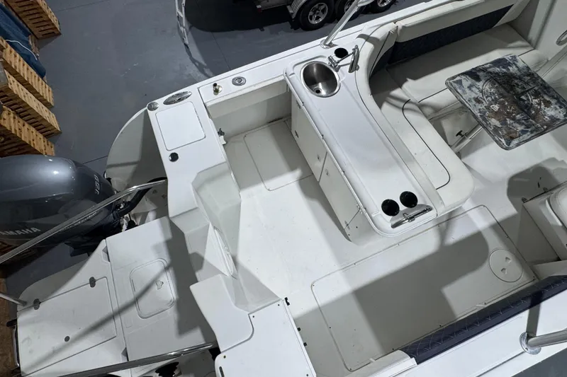Slide: The Image of 2003 Glacier Bay 2640SX Renegade boat interior with seating, sink, and Yamaha engine. - 22