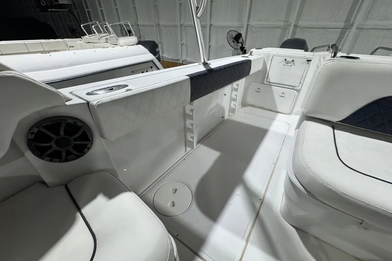 Slide: The Image of 2003 Glacier Bay 2640SX Renegade boat interior with white seating and speaker. - 25