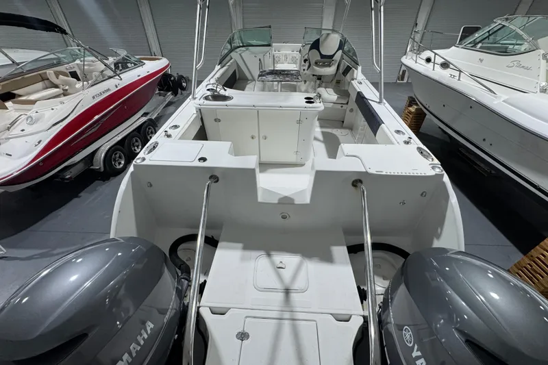 Slide: The Image of 2003 Glacier Bay 2640SX Renegade boat with dual Yamaha engines in a showroom. - 28