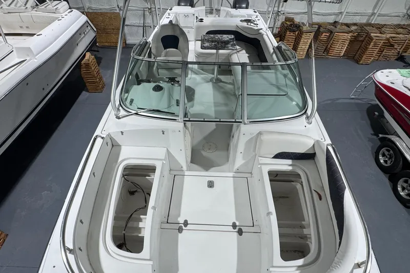 Slide: The Image of 2003 Glacier Bay 2640SX Renegade boat in storage, featuring open compartments and seating. - 30